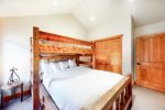 Bright bedroom with a double sized bed, and twin bed